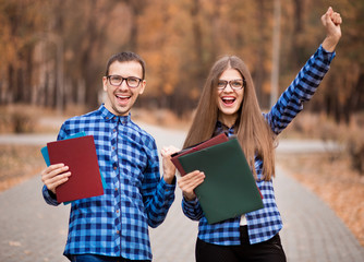 Two excited students with approved exams in street