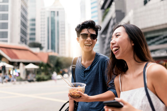 Smiling couple chatting and having fun in the street.