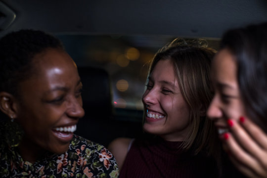 Three girls in a taxi together