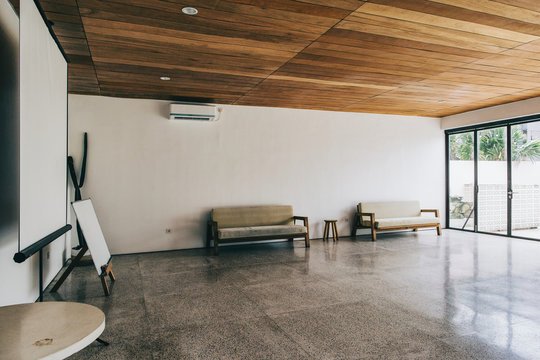 Empty Conference Room With Sofas, Whiteboard and Projection Scre