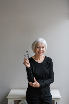Studio portrait of senior woman on simple grey background