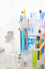 A pipette dropping sample into a test tube,abstract science background