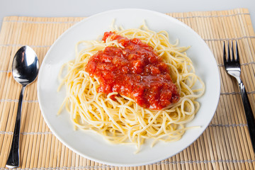 Macaroni with tomato sauce on white background