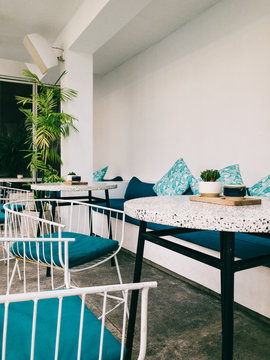 Minimalist White Lounge Area With Coffee Tables in Hip Beach Clu