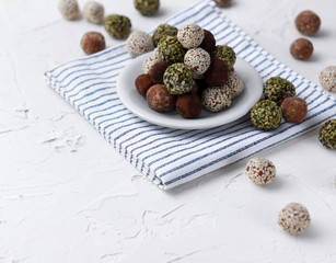 Homemade organic healthy raw energy sweet balls on a plate with a napkin.