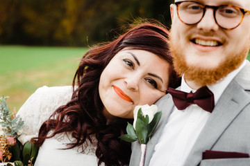 happy bride leaning on the groom