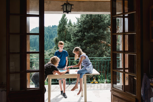 three kids playing a board game