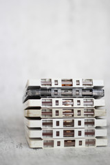 Stacked white cassette tapes on gray background