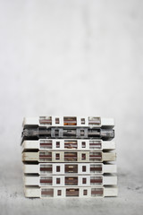Stacked white cassette tapes on gray background