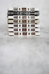 Stacked white cassette tapes on gray background