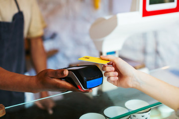 Anonymous costumer paying with phone in a grocery store.