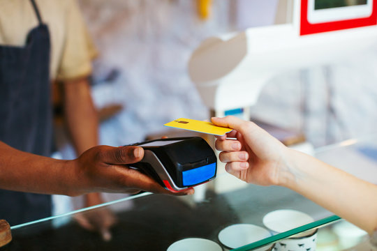 Anonymous costumer paying with phone in a grocery store.