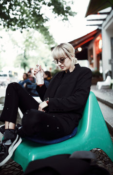Woman drinking lemonade in a coffee shop outdoors