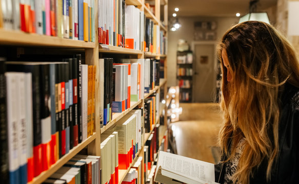 Woman reading a book - Powered by Adobe