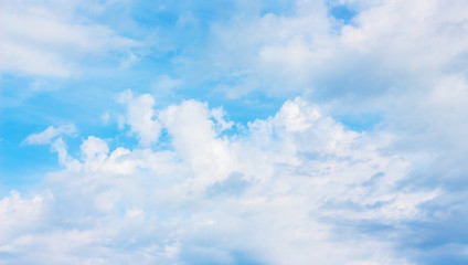 Blue sky with white curly clouds, background for design_