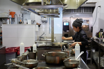 Female cook at work in a restaurant kitchen