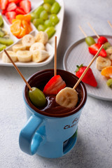 Sweet chocolate fondue with fruits