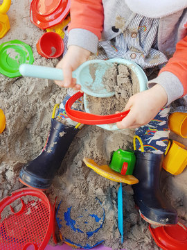 Toddler playing in sandbox