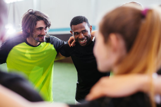 Soccer players training with a coach.