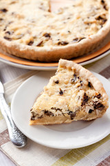 Slice of chicken tart with mushrooms and cheese on a plate