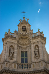 Fototapeta na wymiar Catania baroque example in the roof of Collegita basilica, historical decorations in blue sky