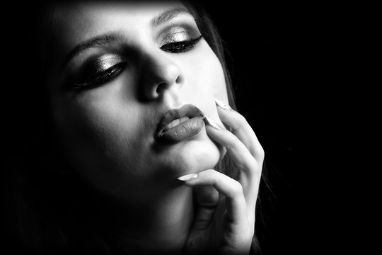 Beautiful sensual woman with gorgeous eyes, long eyelashes, sexy lips and stunning look. Vogue style portrait. Style & Beauty. Fine Art photo. Close up. Black and White Photography.