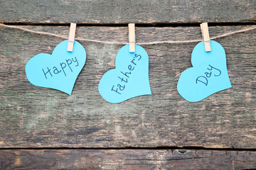 Text Happy Fathers Day hanging on wooden background