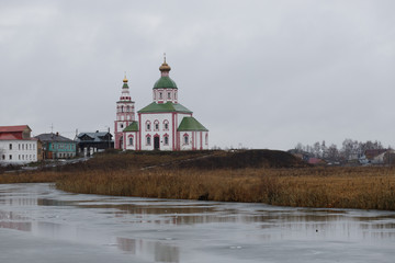 Kremlin in Susdal during a moody winter day with lush orange tones and typical green roof (Susdal,...