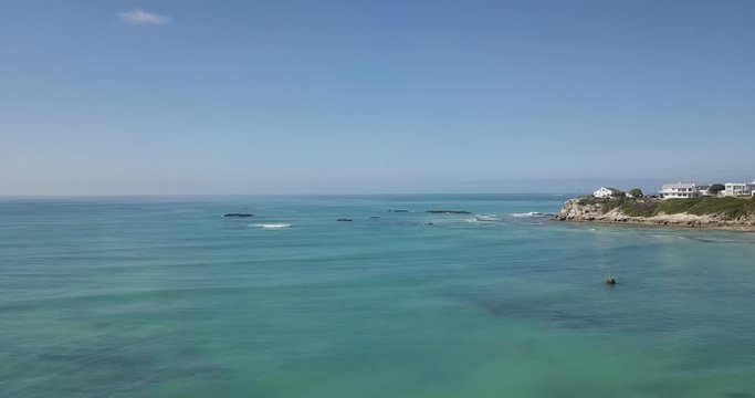 Approaching a peninsular with offshore reefs on the South African coast, drone