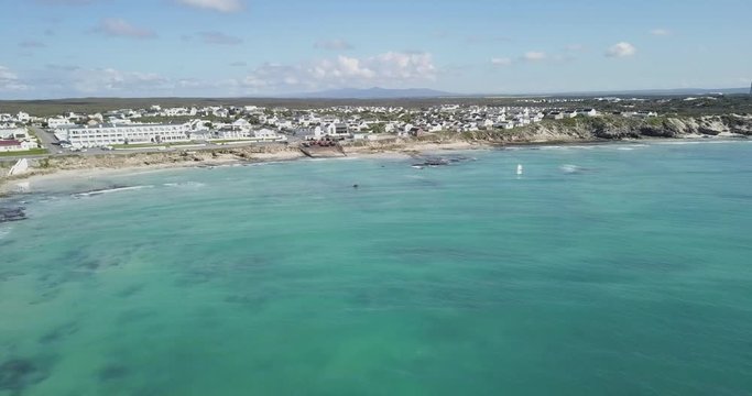 Aerial view of the sea and village of Arniston on the Cape coast, drone forward
