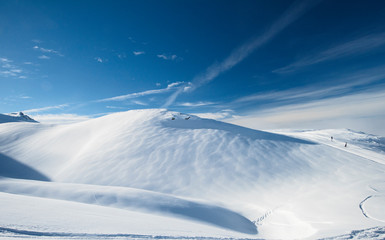 Panoramic view across snow covered slope on alpine mountain