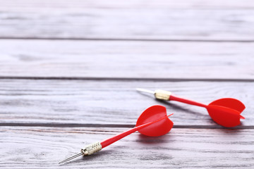 Red dart on wooden table