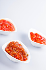 Tomato sauce cups on white background