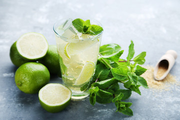 Mojito cocktail in glass on grey wooden table