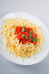 Macaroni with tomato sauce on white background