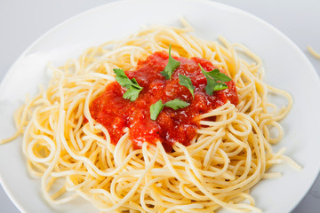 Macaroni with tomato sauce on white background