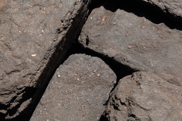 Briquette peat stacked nearby. Close-up. View from above.