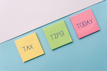 Text sign showing Tax Tips. Business photo showcasing compulsory contribution to state revenue levied by government Pastel colour note papers placed sideways on the of softhued backdrop