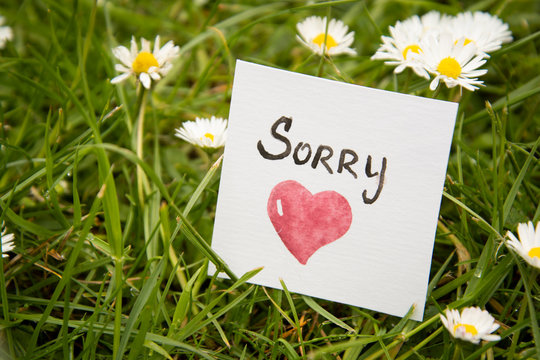 Sorry. Sticker with sorry inscription and red heart. I'm sorry lettering.