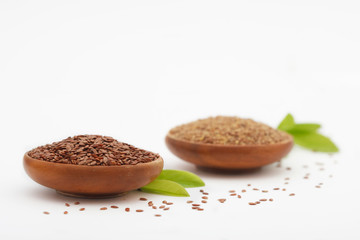 Flax seed and grinded flaxseed in wooden bowls - Linum usitatissimum. Healthy food.