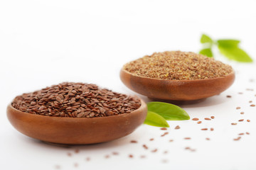 Flax seed and grinded flaxseed in wooden bowls - Linum usitatissimum. Healthy food.