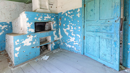 Blue interior of the kitchen of an abandoned house in Chernobyl exclusion zone in Belarus