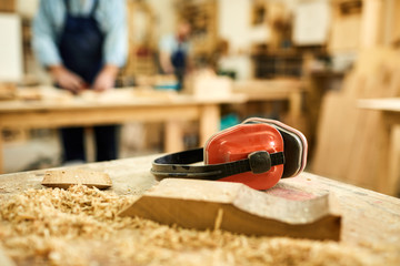 Close up of carpenters workstation with wood shavings on table, copy space