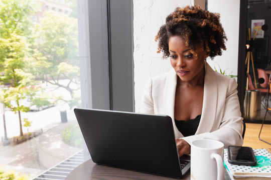Businesswoman works on laptop