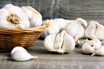 Garlic and garlic cloves on a wooden cutting board. Product photo of garlic. Healthy lifestyle. Source of antioxidants and vitamins. Vegetarian and vegan diet.