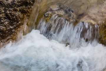 flow of water between the rocks of a mountain stream