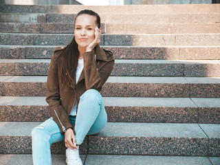 Portrait of beautiful brunette model dressed in summer hipster jacket and jeans clothes. Trendy...