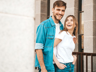 Portrait of smiling beautiful girl and her handsome boyfriend. Woman in casual summer jeans clothes. Happy cheerful family. Female having fun on the street background. Hugging