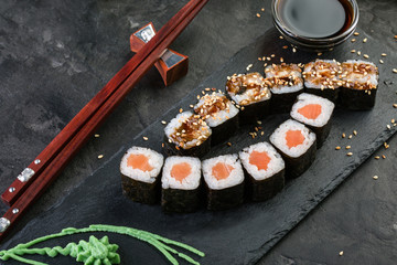 rolls on a black stone background, japanese cuisine