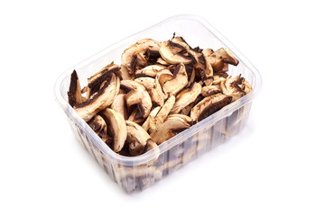 Sliced dried champignon mushrooms, close-up, isolated on white background